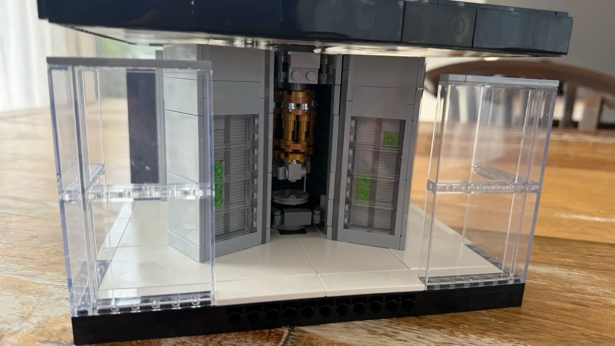 A LEGO model of an IBM Quantum computer with a golden chandelier inside